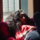 calm young ethnic lady relaxing on sofa at home